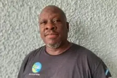 A man standing in front of a wall.