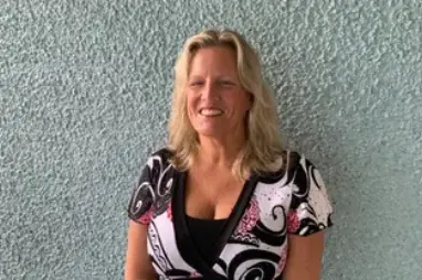 A woman standing in front of a wall.